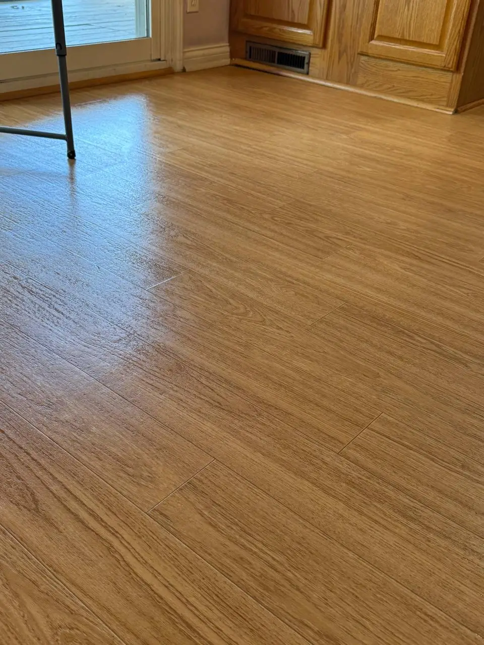 The same kitchen floor after cleaning, with the dark residue removed.